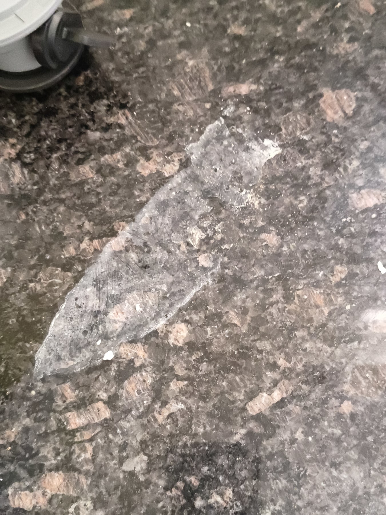Cloudy residue or staining on dark stone surface included under deep cleaning